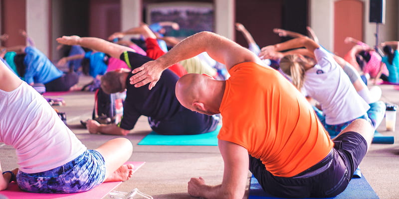 Multiple people taking part in a Yoga class